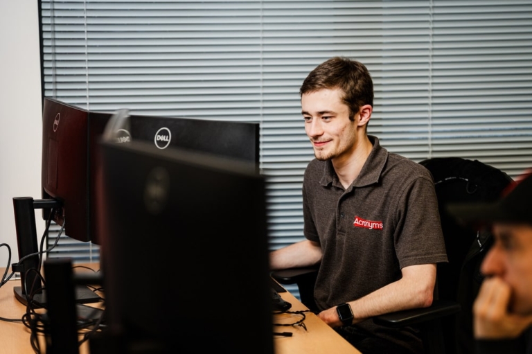 a man providing cyber security services sat at his desk
