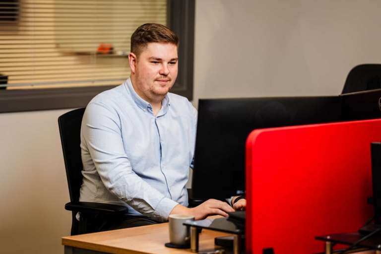 A Man Providing It Infrastructure Services By Typing On His Computer