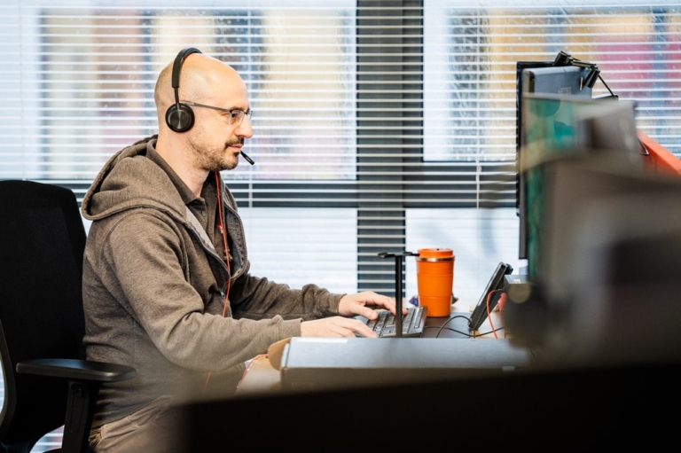 A man providing IT Support at his desk