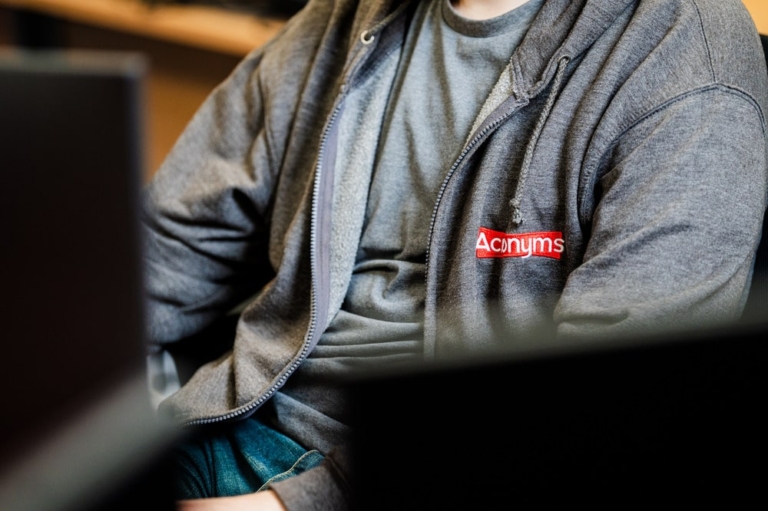 A Close Up Of A Person Wearing An Acronyms Jacket