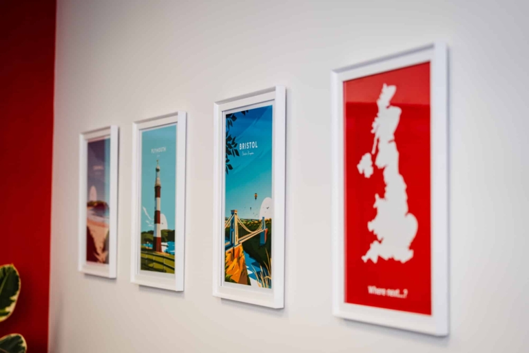 A Close Up Of Framed Maps On A Wall