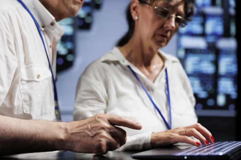 IT providers looking at a laptop